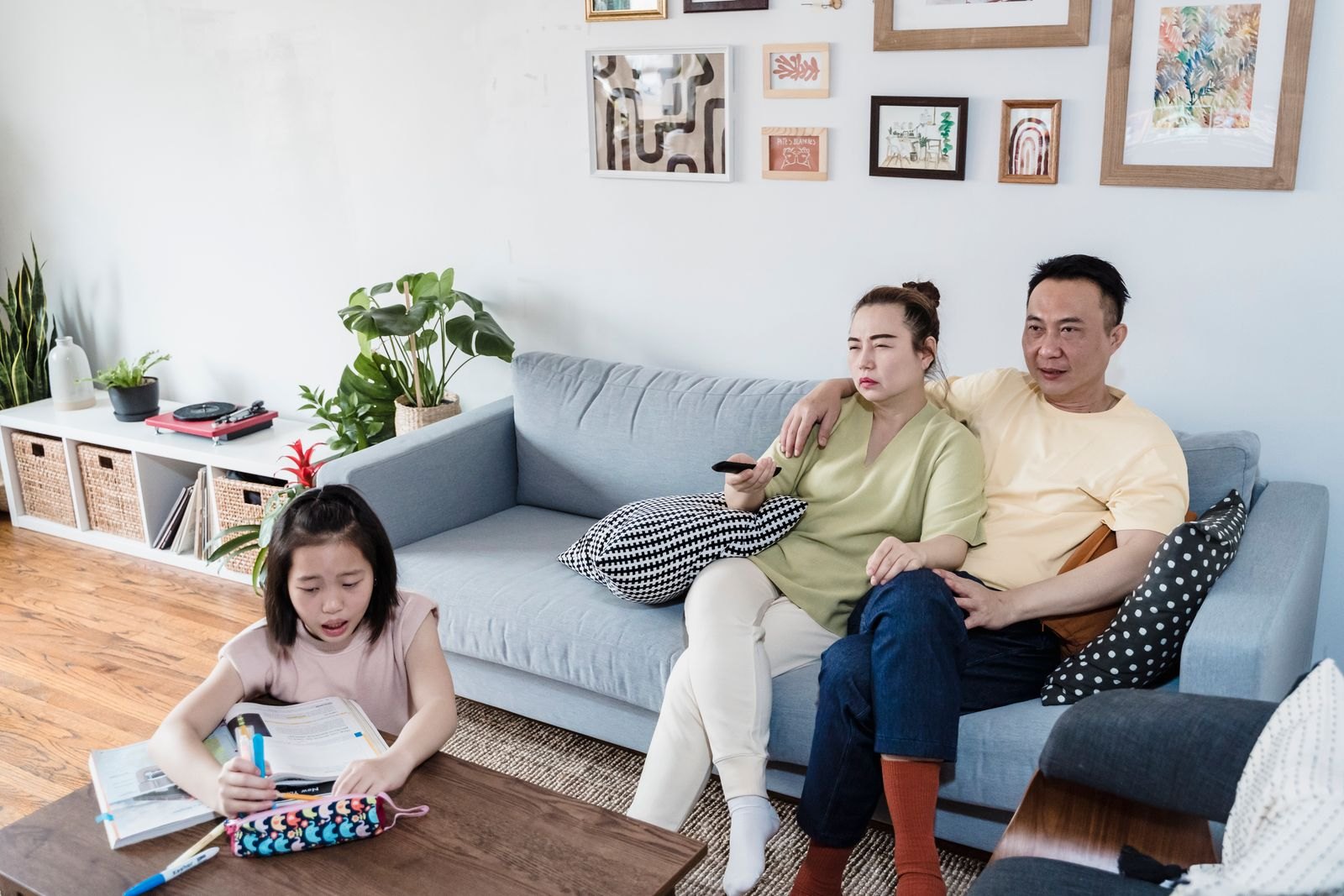 Indian family at home — parents and child in a living room